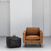industrial tan leather armchair with black ottoman at EDITO Furniture