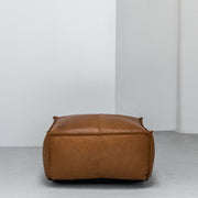 Large contemporary tan leather ottoman with raw edge at EDITO Furniture