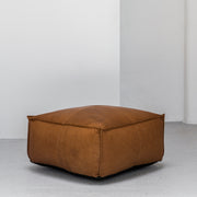 Large contemporary tan leather ottoman with raw edge at EDITO Furniture