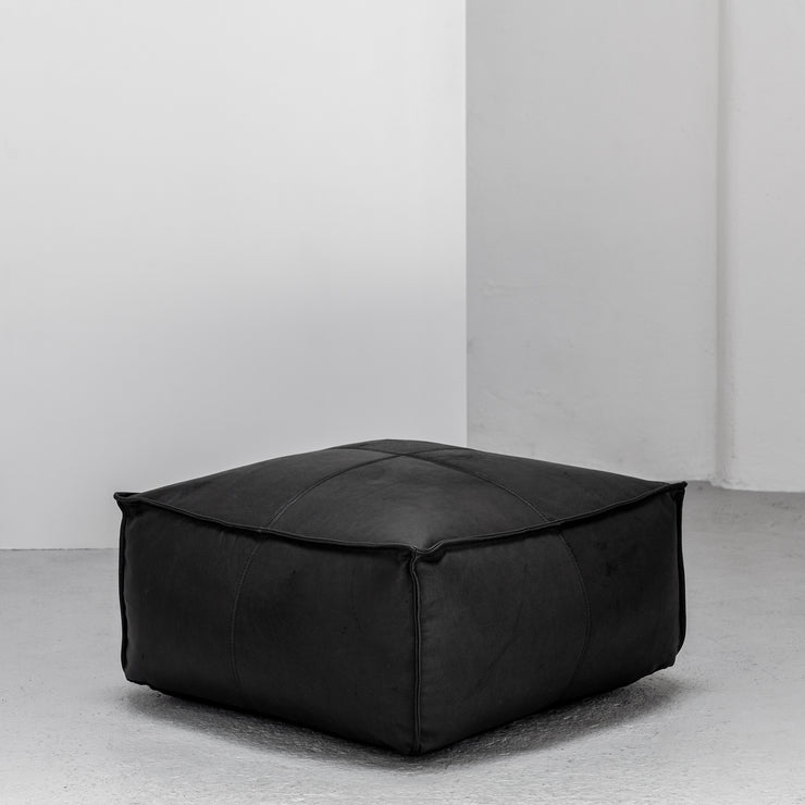 Large contemporary black leather ottoman with raw edge at EDITO Furniture