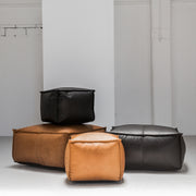 Black and tan leather ottomans at EDITO Furniture