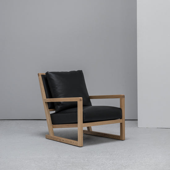 scandinavian Camerich Simon Armchair black leather and oak at EDITO Furniture