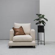 Camerich Lazytime Armchair with tan cushion next to plant at EDITO
